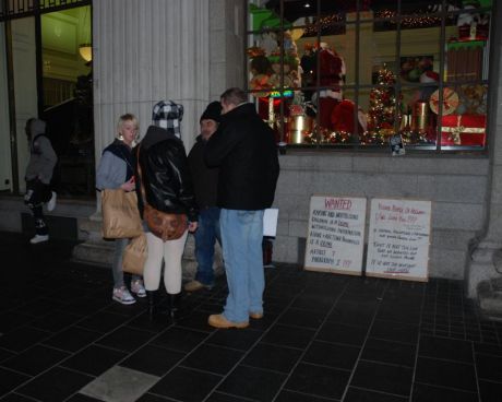 Shoppers engage with Kevin about the protest.