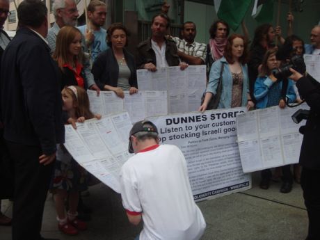 Click on image to see full-sized version Passer by stops to sign the petition before it is handed in
