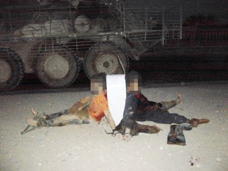 Click on image to see full-sized version This photo of two dead men comes from the collection of one of the suspects.