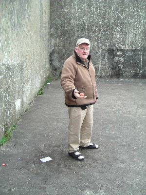 Click on image to see full-sized version Archbishop Michael Desmond Hynes prepares to serve on the dusty alley in Tullyvin.